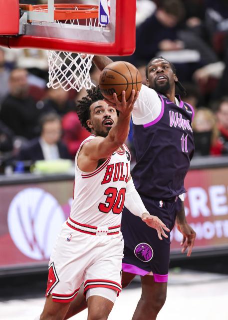 (251230) -- CHICAGO, Dec. 30, 2025 (Xinhua) -- Chicago Bulls' Tre Jones (L) goes to the basket during the 2025-2026 NBA regular season basketball game between Minnesota Timberwolves and Chicago Bulls in Chicago, the United States, Dec. 29, 2025. (Photo by Joel Lerner/Xinhua)