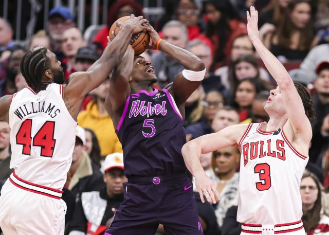 (251230) -- CHICAGO, Dec. 30, 2025 (Xinhua) -- Minnesota Timberwolves' Anthony Edwards (C) drives to the basket against Chicago Bulls' Patrick Williams (L) and Josh Giddey during the 2025-2026 NBA regular season basketball game between Minnesota Timberwolves and Chicago Bulls in Chicago, the United States, Dec. 29, 2025. (Photo by Joel Lerner/Xinhua)