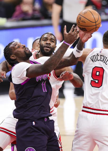 (251230) -- CHICAGO, Dec. 30, 2025 (Xinhua) -- Minnesota Timberwolves' Naz Reid (L) grabs a rebound during the 2025-2026 NBA regular season basketball game between Minnesota Timberwolves and Chicago Bulls in Chicago, the United States, Dec. 29, 2025. (Photo by Joel Lerner/Xinhua)