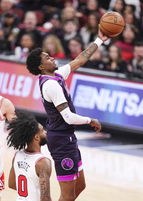 (251230) -- CHICAGO, Dec. 30, 2025 (Xinhua) -- Minnesota Timberwolves' Jaden McDaniels (top) goes to the basket during the 2025-2026 NBA regular season basketball game between Minnesota Timberwolves and Chicago Bulls in Chicago, the United States, Dec. 29, 2025. (Photo by Joel Lerner/Xinhua)