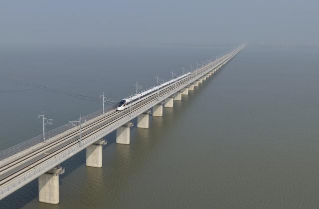 (251230) -- HEFEI, Dec. 30, 2025 (Xinhua) -- A drone photo taken on Dec. 30, 2025 shows a train running on a bridge crossing the Huaihongxin River of the Hefei-Xinyi high-speed railway in east China's Anhui Province.
  The Hefei-Sixian section of the Hefei-Xinyi high-speed railway was officially put into operation on Tuesday, marking the opening of another fast passenger line between Hefei City and eastern Anhui Province.
  The Hefei-Xinyi high-speed railway starts from Hefei West Railway Station in Hefei, and terminates at Xinyi East Railway Station in Xinyi City of Jiangsu Province. Spanning approximately 335 kilometers and with a design speed of 350 kilometers per hour, the railway is being constructed in phases. 
  The newly-opened section of the railway stretches 198 kilometers, setting five newly-built stations, namely Hefei West, Dingyuan East, Mingguang West, Wuhe, and Sixian East railway stations. (Xinhua/Huang Bohan)