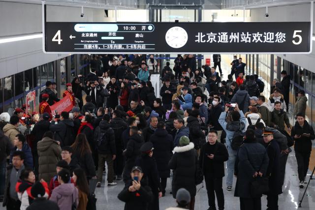 (251230) -- BEIJING, Dec. 30, 2025 (Xinhua) -- Passengers walk on the platform to take a train bound for Tangshan in north China's Hebei Province, at Beijing Tongzhou Railway Station in Beijing, capital of China, Dec. 30, 2025.
  The railway station, located in the comprehensive transportation hub of Beijing's sub-center Tongzhou District, was officially put into operation on Tuesday. (Xinhua/Zhang Chenlin)
