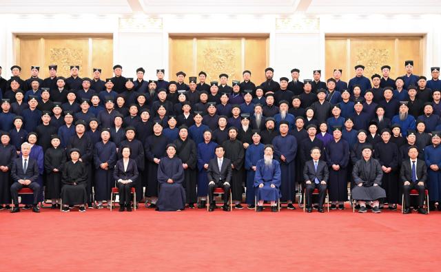 (251230) -- BEIJING, Dec. 30, 2025 (Xinhua) -- Wang Huning, a member of the Standing Committee of the Political Bureau of the Communist Party of China (CPC) Central Committee and chairman of the Chinese People's Political Consultative Conference (CPPCC) National Committee, poses for a group photo with delegates attending the 11th national congress of the Taoist Association of China in Beijing, capital of China. The 11th national congress of the Taoist Association of China was held on Monday and Tuesday in Beijing. (Xinhua/Li Xiang)