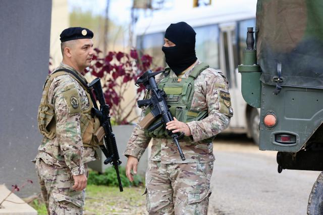 (251230) -- SIDON, Dec. 30, 2025 (Xinhua) -- Soldiers from the Lebanese army work near trucks carrying weapons received from the Ain al-Hilweh Palestinian refugee camp in Sidon, Lebanon, Dec. 30, 2025. The Lebanese army on Tuesday received the fifth batch of weapons handed over from Palestinian refugee camps in Lebanon, as part of a state-led plan to centralize arms under national authority. (Photo by Ali Hashisho/Xinhua)