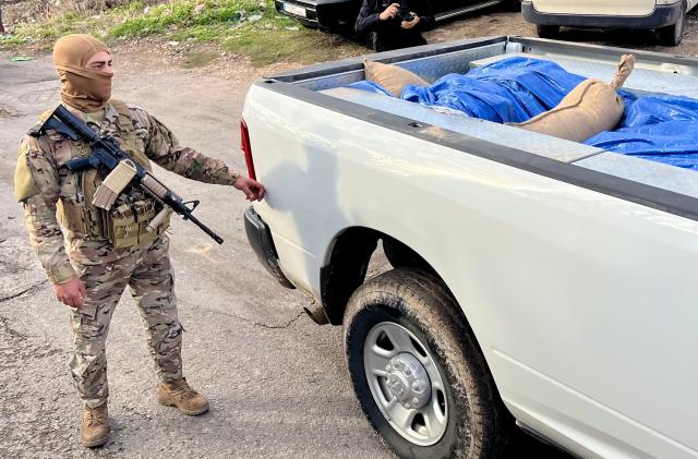 (251230) -- SIDON, Dec. 30, 2025 (Xinhua) -- A soldier from the Lebanese army guards a truck carrying weapons received from the Ain al-Hilweh Palestinian refugee camp in Sidon, Lebanon, Dec. 30, 2025. The Lebanese army on Tuesday received the fifth batch of weapons handed over from Palestinian refugee camps in Lebanon, as part of a state-led plan to centralize arms under national authority. (Photo by Ali Hashisho/Xinhua)
