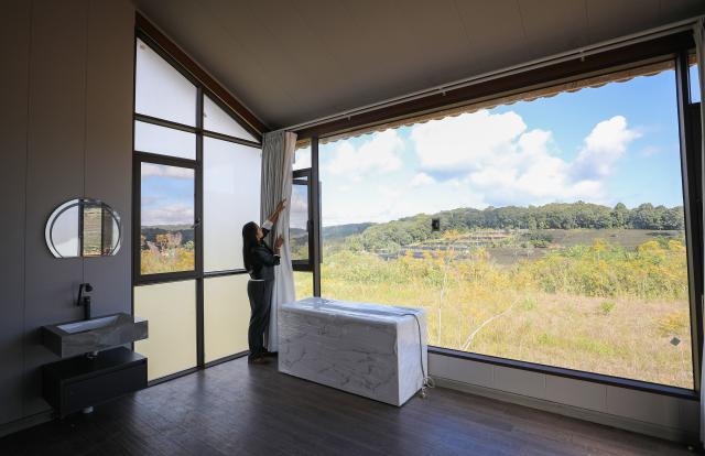 (251231) -- JINGHONG, Dec. 31, 2025 (Xinhua) -- Wei Chun checks a homestay in Dadugang Township of Jinghong City, Xishuangbanna Dai Autonomous Prefecture, southwest China's Yunnan Province, Dec. 20, 2025. Wei Chun used to work at an international hotel in a first-tier city. In June 2024, she became an agricultural manager of a collective economy company in Dadugang Township, a role locals refer to as the "Village CEO." 
   Under her leadership, idle factory buildings and vacant land were transformed into cafes, educational spaces, and campsites, providing recreational spaces for visitors. Wei also offered free training in coffee making, tea art, and rural hospitality management, improving service quality and expanding employment opportunities for villagers.
   By 2025, Wei has helped more than 100 villagers acquire new skills and attracted nine talents returning home to start businesses here. (Xinhua/Du Xiaoyi)