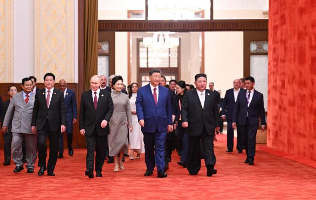 (251231) -- BEIJING, Dec. 31, 2025 (Xinhua) -- Chinese President Xi Jinping and his wife Peng Liyuan enter the banquet hall together with the foreign leaders and their spouses attending a reception commemorating the 80th anniversary of the victory in the Chinese People's War of Resistance against Japanese Aggression and the World Anti-Fascist War at the Great Hall of the People in Beijing, capital of China, Sept. 3, 2025. Xi, also general secretary of the Communist Party of China Central Committee and chairman of the Central Military Commission, attended and addressed the reception. (Xinhua/Xie Huanchi)