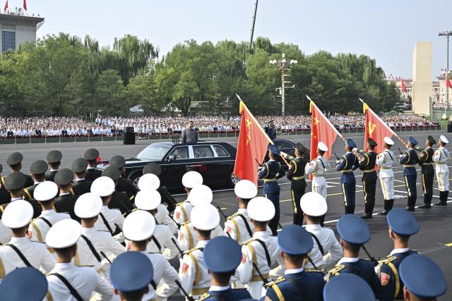 (251231) -- BEIJING, Dec. 31, 2025 (Xinhua) -- Chinese President Xi Jinping, also general secretary of the Communist Party of China Central Committee and chairman of the Central Military Commission, salutes the flags of the Party, the nation and the army with a fixed gaze as he reviews troops in a Hongqi limousine during a grand gathering commemorating the 80th anniversary of the victory in the Chinese People's War of Resistance against Japanese Aggression and the World Anti-Fascist War in Beijing, capital of China, Sept. 3, 2025. Xi delivered an important speech at the gathering and reviewed troops. (Xinhua/Yin Bogu)