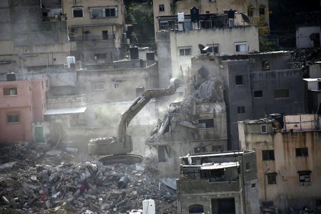 (260101) -- TULKARM, Jan. 1, 2026 (Xinhua) -- An Israeli bulldozer demolishes a Palestinian building in the Nur Shams refugee camp, east of the city of Tulkarm in the West Bank, on Dec. 31, 2025. (Photo by Nidal Eshtayeh/Xinhua)