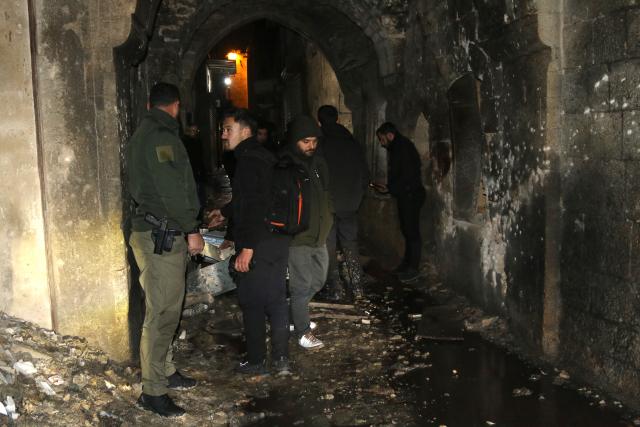 (260101) -- DAMASCUS, Jan. 1, 2026 (Xinhua) -- Photo taken on early hours of Jan. 1, 2026 shows people checking the site of the suicide bombing in Aleppo city, northern Syria. One person was killed, and several members of Syria's internal security forces were wounded on Wednesday after a suicide bomber targeted a police patrol in the Bab al-Faraj area of northern Syria's Aleppo city, according to several state media reports. (Str/Xinhua)
