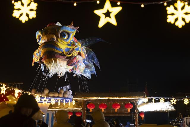 (260101) -- HARBIN, Jan. 1, 2026 (Xinhua) -- This photo shows a giant dragon-head fish lantern at the Heilongjiang Radio and TV Tower square in Harbin, northeast China's Heilongjiang Province, Dec. 31, 2025.
  Many scenic spots in the "Ice City" Harbin was illuminated Wednesday night, drawing tourists to celebrate the New Year. (Xinhua/Zhang Tao)