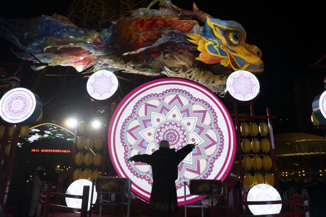 (260101) -- HARBIN, Jan. 1, 2026 (Xinhua) -- This photo shows a giant dragon-head fish lantern at the Heilongjiang Radio and TV Tower square in Harbin, northeast China's Heilongjiang Province, Dec. 31, 2025.
  Many scenic spots in the "Ice City" Harbin was illuminated Wednesday night, drawing tourists to celebrate the New Year. (Xinhua/Zhang Tao)