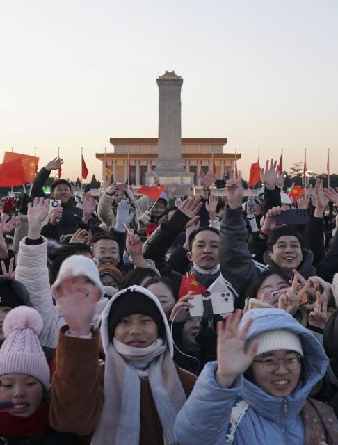 (260101) -- BEIJING, Jan. 1, 2026 (Xinhua) -- People cheer after watching a grand national flag-raising ceremony at Tian'anmen Square in Beijing, capital of China, Jan. 1, 2026. (Xinhua/Xie Han)