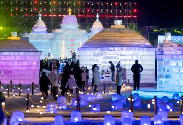 (260101) -- HOHHOT, Jan. 1, 2026 (Xinhua) -- Tourists visit an ice and snow festival at the Daheihe military cultural park in Hohhot, north China's Inner Mongolia Autonomous Region, Dec. 31, 2025.
  The event kicked off on Wednesday, attracting tourists to enjoy lanterns, ice sculptures and snacks. (Xinhua/Lian Zhen)
