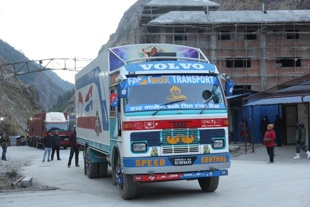(260101) -- BEIJING, Jan. 1, 2026 (Xinhua) -- A truck waits to go through the Gyirong Port in southwest China's Xizang Autonomous Region via a steel temporary access bridge at the Rasuwa Port in Nepal, Jan. 1, 2026. China-Nepal Gyirong-Rasuwa Port, one of the largest land ports between the two countries, resumed customs and passenger clearance on Thursday morning, nearly six months after the area was struck by flood. (Xinhua/Zhang Ping)