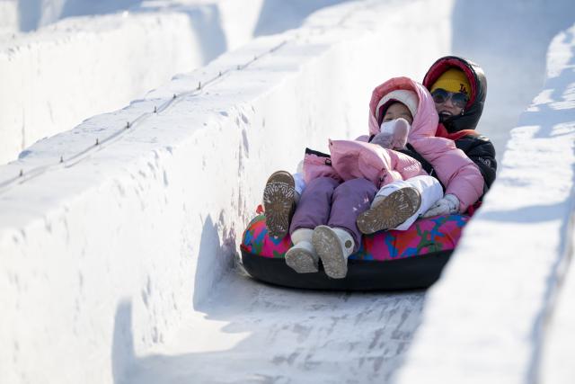 (260101) -- BEIJING, Jan. 1, 2026 (Xinhua) -- People enjoy snow slide during the 8th Harbin Songhua River Ice and Snow Carnival held in Harbin, northeast China's Heilongjiang Province on Jan. 1, 2026. People across China celebrate the arrival of 2026 with a wide range of festivities on Thursday, the first day of the year. (Xinhua/Zhang Tao)