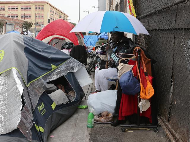 (260101) -- LOS ANGELES, Jan. 1, 2026 (Xinhua) -- A homeless person rests by the tents on the sidewalk in downtown Los Angeles, California, the United States on Dec. 31, 2025. (Photo by Qiu Chen/Xinhua)