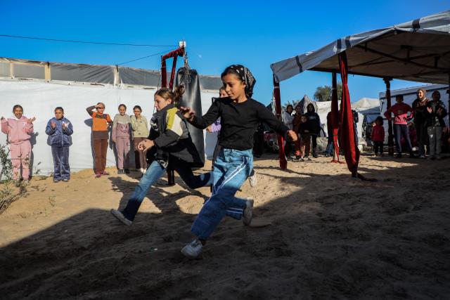 (260101) -- GAZA, Jan. 1, 2026 (Xinhua) -- Palestinian girls take part in a boxing training session aimed for psychological relief and physical empowerment at a displacement camp in the Al-Mawasi area of Khan Younis, southern Gaza Strip, on Dec. 31, 2025. (Photo by Rizek Abdeljawad/Xinhua)