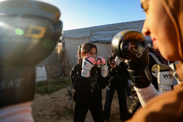 (260101) -- GAZA, Jan. 1, 2026 (Xinhua) -- Palestinian girls take part in a boxing training session aimed for psychological relief and physical empowerment at a displacement camp in the Al-Mawasi area of Khan Younis, southern Gaza Strip, on Dec. 31, 2025. (Photo by Rizek Abdeljawad/Xinhua)