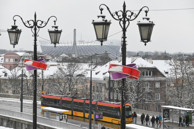 (260101) -- WARSAW, Jan. 1, 2026 (Xinhua) -- A tram runs along a street with the National Stadium seen in the background in Warsaw, Poland on Jan. 1, 2026. (Photo by Aleksy Witwicki/Xinhua)