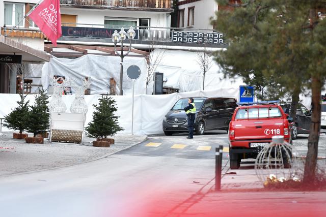 (260101) -- CRANS-MONTANA, Jan. 1, 2026 (Xinhua) -- A security force works at the scene of a fire at a bar in the Crans-Montana ski resort in Valais Canton of southwestern Switzerland, Jan. 1, 2026. Around 40 people died and over 110 others were injured after a fire broke out at a bar in the Crans-Montana ski resort, local police said on Thursday. (Xinhua/Lian Yi)