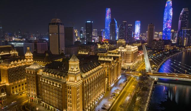 (260102) -- TIANJIN, Jan. 2, 2026 (Xinhua) -- An aerial drone photo taken on Jan. 1, 2026 shows a view of the Jiefang North Road historical and cultural block in Tianjin, north China. Located on the south bank of the Haihe River in Tianjin, the century-old Jiefang North Road historical and cultural block used to be a neighborhood where many banks clustered. Now, the streets there decorated with festive lights have attracted many tourists for a citywalk during the New Year's Day holiday. (Xinhua/Zhao Zishuo)