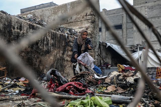 (260102) -- GAZA, Jan. 2, 2026 (Xinhua) -- A displaced Palestinian woman inspects the damage to her temporary tent after a fire broke out the previous night, in Gaza City on Jan. 2, 2026. (Photo by Rizek Abdeljawad/Xinhua)