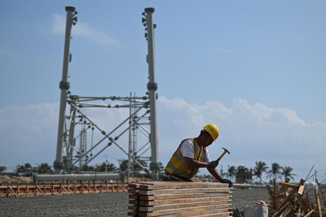 (260103) -- WENCHANG, Jan. 3, 2026 (Xinhua) -- A worker is seen busy at the construction site of the second phase of the Hainan commercial spacecraft launch site in Wenchang, south China's Hainan Province, Dec. 29, 2025. The Wenchang Spacecraft Launch Site located in Wenchang in the northeastern part of Hainan Island is China's first independently designed and constructed green, eco-friendly and modern spaceport. It currently operates two all-weather, multi-directional launch pads, capable of handling heavy payloads. 
  Wenchang is also home to China's first commercial aerospace launch site, which has sent more than 90 satellites into their planned orbits since its maiden launch in November 2024.
  Highly frequent rocket launches have driven the aerospace-themed tourist services in the city. The rocket-viewing platform there attracts lots of spectators for each launch. Tourists flock here to witness the grand scene of rocket launches, and enjoy the breathtaking scenic view of during their visits to homestays, restaurants and cafes. (Xinhua/Pu Xiaoxu)