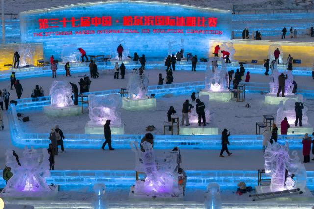 (260103) -- HARBIN, Jan. 3, 2026 (Xinhua) -- This aerial drone photo taken on Jan. 3, 2026 shows competitors working on ice sculptures during the 37th China Harbin International Ice Sculpture Competition at the Harbin Ice-Snow World in Harbin, northeast China's Heilongjiang Province. The competition kicked off here on Friday. (Xinhua/Zhang Tao)