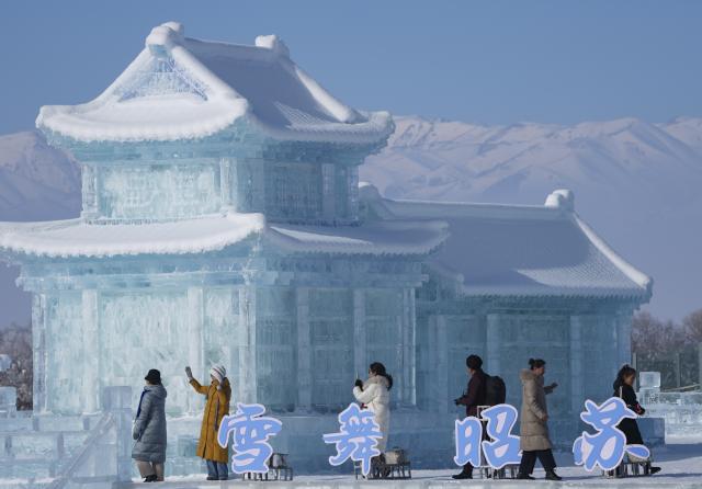 (260103) -- ZHAOSU, Jan. 3, 2026 (Xinhua) -- People view ice sculptures at an ice-and-snow themed park in Zhaosu County, Ili Kazak Autonomous Prefecture, northwest China's Xinjiang Uygur Autonomous Region, Jan. 3, 2026. Leveraging its unique ice and snow resources in winter, Zhaosu County has developed diverse winter tourist services to attract visitors. (Xinhua/Hu Huhu)