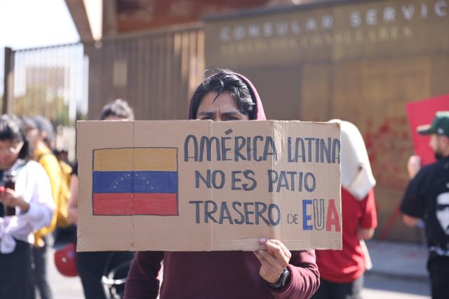 (260104) -- MEXICO CITY, Jan. 4, 2026 (Xinhua) -- People protest with a placard reading "Latin America is not the backyard of the United States" outside the U.S. Embassy in Mexico City, capital of Mexico, on Jan. 3, 2026. (Xinhua/Li Mengxin)