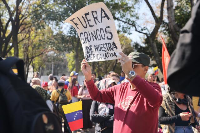(260104) -- MEXICO CITY, Jan. 4, 2026 (Xinhua) -- People protest with a placard reading "Get Americans out of our Latin America" outside the U.S. Embassy in Mexico City, capital of Mexico, on Jan. 3, 2026. (Xinhua/Li Mengxin)