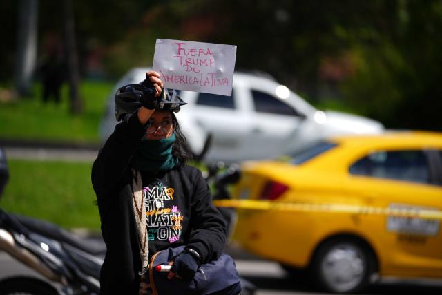 (260104) -- BOGOTA, Jan. 4, 2026 (Xinhua) -- A woman holds a sign during a rally in support of Venezuela outside the U.S. Embassy in Bogota, Colombia, Jan. 3, 2026. The U.S. military launched a series of attacks against Venezuela early Saturday morning, reportedly capturing Venezuelan President Nicolas Maduro and flying him out of the country. (Photo by Andres Moreno/Xinhua)