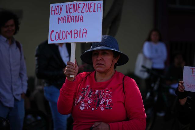 (260104) -- BOGOTA, Jan. 4, 2026 (Xinhua) -- A woman holds a sign during a rally in support of Venezuela outside the U.S. Embassy in Bogota, Colombia, Jan. 3, 2026. The U.S. military launched a series of attacks against Venezuela early Saturday morning, reportedly capturing Venezuelan President Nicolas Maduro and flying him out of the country. (Photo by Andres Moreno/Xinhua)