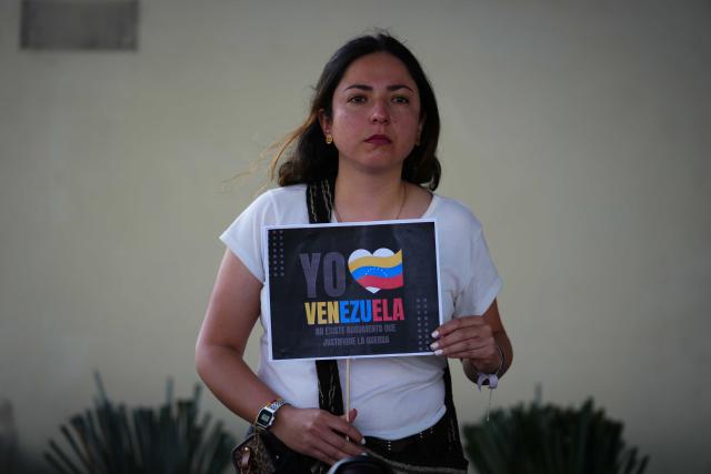 (260104) -- BOGOTA, Jan. 4, 2026 (Xinhua) -- A woman holds a sign during a rally in support of Venezuela outside the U.S. Embassy in Bogota, Colombia, Jan. 3, 2026. The U.S. military launched a series of attacks against Venezuela early Saturday morning, reportedly capturing Venezuelan President Nicolas Maduro and flying him out of the country. (Photo by Andres Moreno/Xinhua)