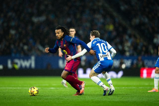 (260104) --BARCELONA, Jan. 4, 2026 (Xinhua) -- Barcelona's Jules Kounde (L) vies with Espanyol's Pol Lozano during LaLiga football match between RCD Espanyol and FC Barcelona in RCDE Stadium, Cornella, Barcelona, Spain, Jan. 3, 2026. (Photo by Joan Gosa/Xinhua)