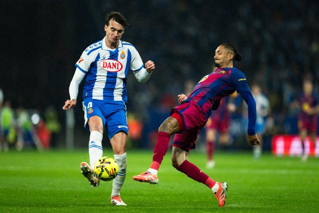 (260104) --BARCELONA, Jan. 4, 2026 (Xinhua) -- Barcelona's Raphinha (R) vies with Espanyol's Urko Gonzalez de Zarate during LaLiga football match between RCD Espanyol and FC Barcelona in RCDE Stadium, Cornella, Barcelona, Spain, Jan. 3, 2026. (Photo by Joan Gosa/Xinhua)