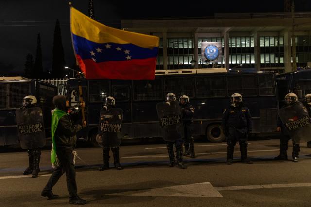 (260104) -- ATHENS, Jan. 4, 2026 (Xinhua) -- People in support of Venezuela protest outside the U.S. Embassy in Athens, Greece, Jan. 3, 2026. The U.S. military strike against Venezuela and capture of its president, Nicolas Maduro, has shocked the international community, triggering a steady stream of condemnation and serious concerns worldwide. (Xinhua/Marios Lolos)