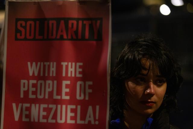 (260104) -- ATHENS, Jan. 4, 2026 (Xinhua) -- A woman in support of Venezuela protests outside the U.S. Embassy in Athens, Greece, Jan. 3, 2026. The U.S. military strike against Venezuela and capture of its president, Nicolas Maduro, has shocked the international community, triggering a steady stream of condemnation and serious concerns worldwide. (Xinhua/Marios Lolos)
