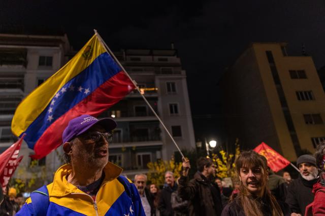 (260104) -- ATHENS, Jan. 4, 2026 (Xinhua) -- People in support of Venezuela protest outside the U.S. Embassy in Athens, Greece, Jan. 3, 2026. The U.S. military strike against Venezuela and capture of its president, Nicolas Maduro, has shocked the international community, triggering a steady stream of condemnation and serious concerns worldwide. (Xinhua/Marios Lolos)
