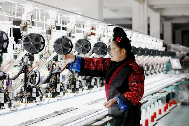 (260104) -- BEIJING, Jan. 4, 2026 (Xinhua) -- A worker operates at an intelligent Miao embroidery workshop in Shibing County of Qiandongnan Miao and Dong Autonomous Prefecture, southwest China's Guizhou Province, Jan. 4, 2026. (Photo by Tai Shengzhi/Xinhua)