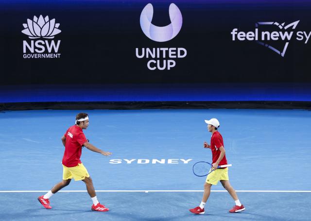 (260104) -- SYDNEY, Jan. 4, 2026 (Xinhua) -- You Xiaodi (R) celebrates with teammate Te Rigele of China against Victoria Mboko/Felix Auger-Aliassime of Canada in the Group B round robin match between China and Canada at the 2026 United Cup tennis tournament in Sydney, Australia, Jan. 4, 2026. (Xinhua/Ma Ping)