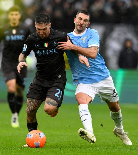 (260104) -- ROME, Jan. 4, 2026 (Xinhua) -- Napoli's Matteo Politano (L) vies with Lazio's Danilo Cataldi during a Serie A football match between Lazio and Napoli in Rome, Italy, Jan. 4, 2026. (Photo by Augusto Casasoli/Xinhua)