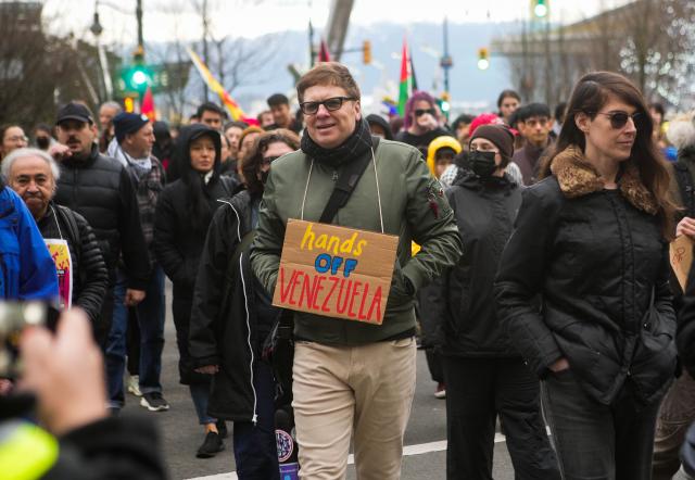 (260105) -- VANCOUVER, Jan. 5, 2026 (Xinhua) -- Protesters march through the downtown area during a rally opposing U.S. attack on Venezuela in Vancouver, Canada, Jan. 4, 2026. Hundreds of demonstrators rallied in downtown Vancouver on Sunday for a "Hands Off Venezuela" protest, condemning U.S. attack on Venezuela. (Photo by Liang Sen/Xinhua)