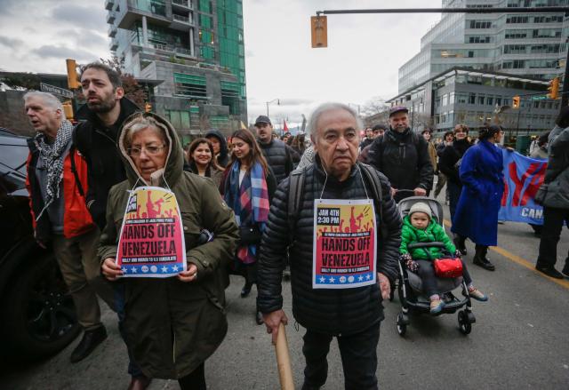 (260105) -- VANCOUVER, Jan. 5, 2026 (Xinhua) -- Protesters march through the downtown area during a rally opposing U.S. attack on Venezuela in Vancouver, Canada, Jan. 4, 2026. Hundreds of demonstrators rallied in downtown Vancouver on Sunday for a "Hands Off Venezuela" protest, condemning U.S. attack on Venezuela. (Photo by Liang Sen/Xinhua)