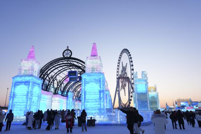 (260105) -- HARBIN, Jan. 5, 2026 (Xinhua) -- People visit the Harbin Ice-Snow World in Harbin, northeast China's Heilongjiang Province, Jan. 5, 2026. The 42nd Harbin International Ice and Snow Festival kicked off at the Harbin Ice-Snow World here on Monday. (Xinhua/Wang Song)