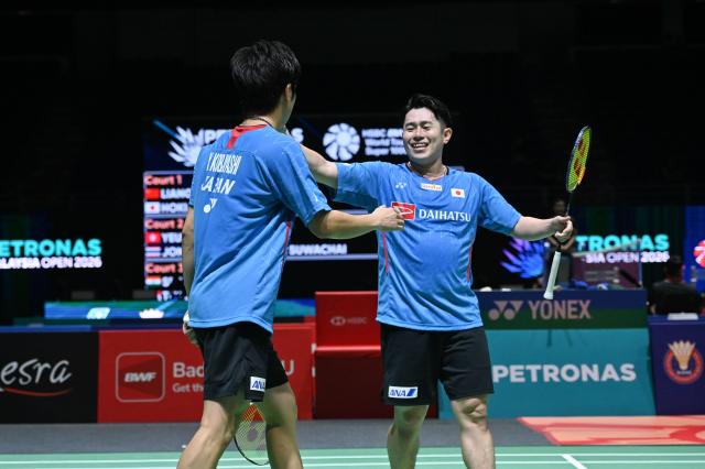 (260106) -- KUALA LUMPUR, Jan. 6, 2026 (Xinhua) -- Hoki Takuro (R)/Kobayashi Yugo of Japan celebrate after winning the men's doubles round of 32 match against Liang Weikeng/Wang Chang of China at the Malaysia Open 2026 badminton tournament in Kuala Lumpur, Malaysia, Jan. 6, 2026. (Photo by Chong Voon Chung/Xinhua)