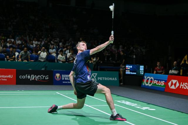 (260106) -- KUALA LUMPUR, Jan. 6, 2026 (Xinhua) -- Rasmus Gemke of Denmark hits a return during the men's singles round of 32 match against Shi Yuqi of China at the Malaysia Open 2026 badminton tournament in Kuala Lumpur, Malaysia, Jan. 6, 2026. (Photo by Chong Voon Chung/Xinhua)