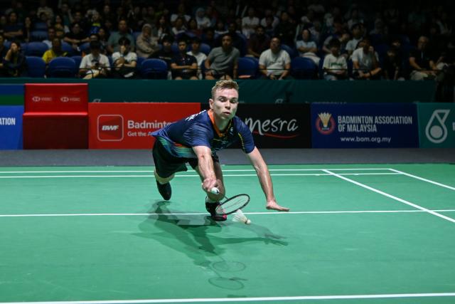 (260106) -- KUALA LUMPUR, Jan. 6, 2026 (Xinhua) -- Rasmus Gemke of Denmark hits a return during the men's singles round of 32 match against Shi Yuqi of China at the Malaysia Open 2026 badminton tournament in Kuala Lumpur, Malaysia, Jan. 6, 2026. (Photo by Chong Voon Chung/Xinhua)