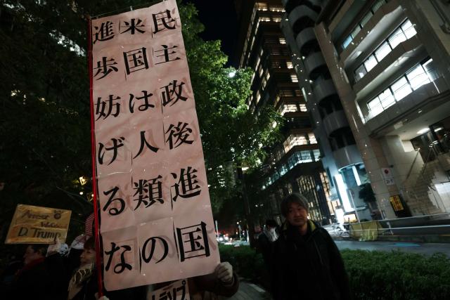 (260106) -- TOKYO, Jan. 6, 2026 (Xinhua) -- People hold a slogan in support of Venezuela during a protest in front of the U.S. embassy in Tokyo, Japan, Jan. 6, 2026. The U.S. military struck Venezuela on Saturday, capturing President Maduro and his wife and transferring them to the United States. (Xinhua/Jia Haocheng)